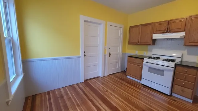 a kitchen with stainless steel appliances a refrigerator and a stove top oven