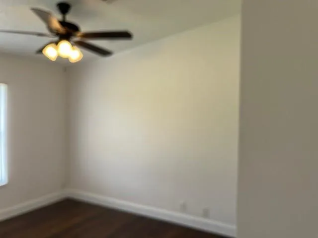 a view of a small space with wooden floor and a window