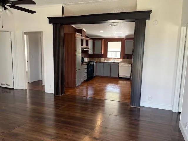 a view of a kitchen with a sink and a refrigerator