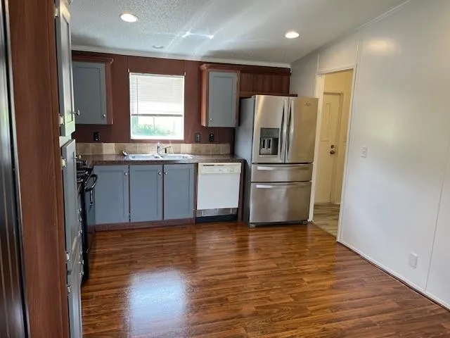 a kitchen with a refrigerator and a sink