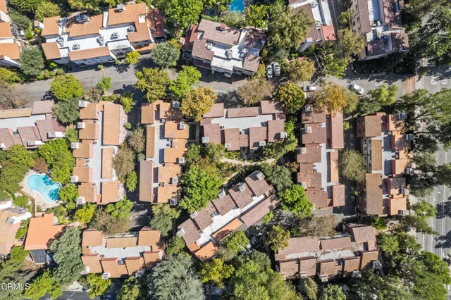 an aerial view of multiple houses with yard