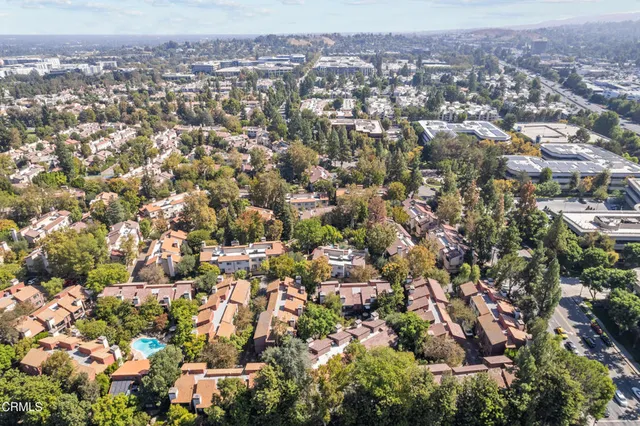 an aerial view of residential houses with city view