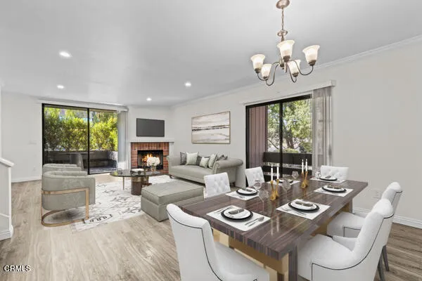 a living room with fireplace furniture and a large window