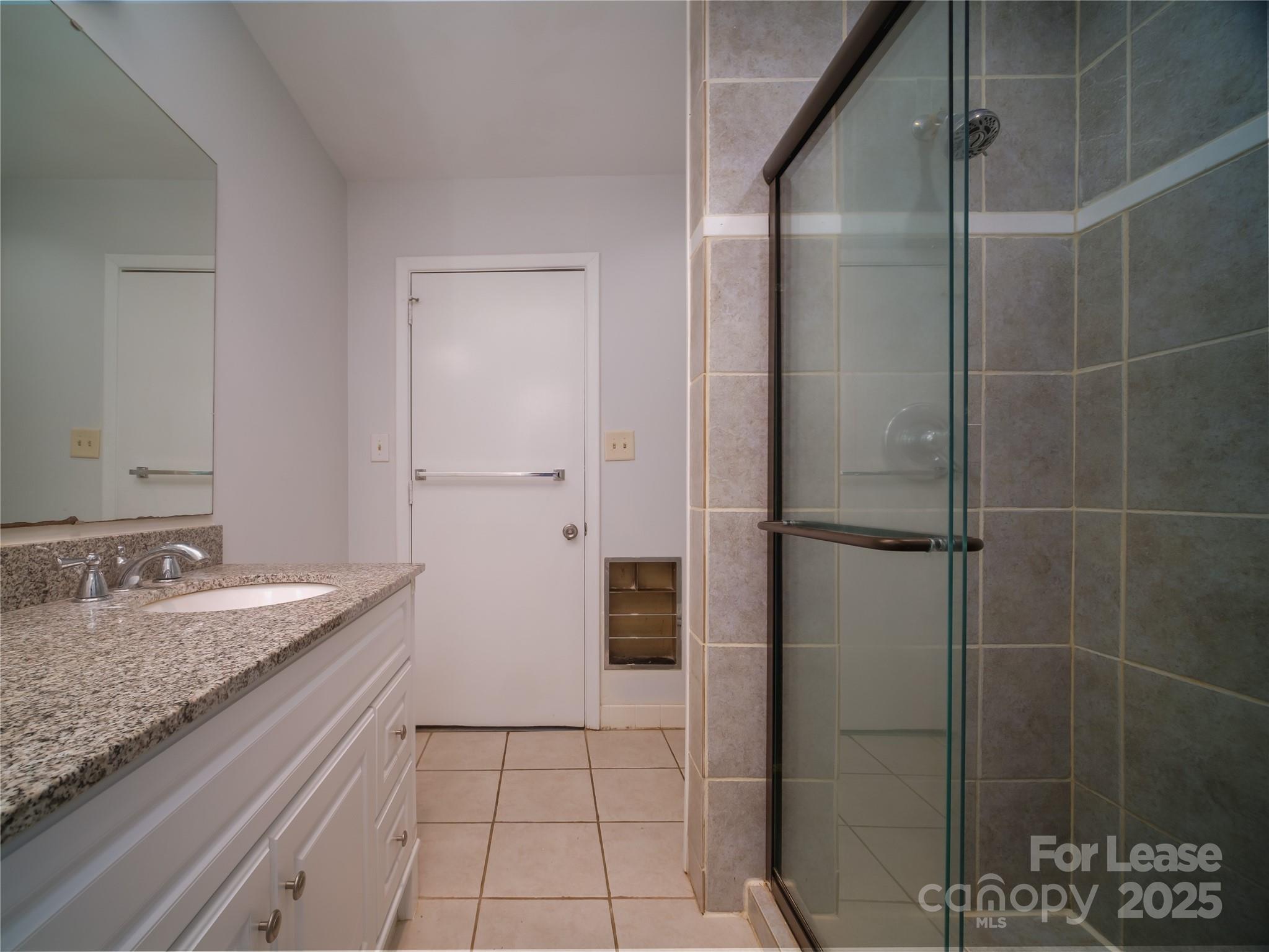 1123 Lynbrook Drive Charlotte, NC 28211 - Photo 11 of 47 a bathroom with a granite countertop sink and a mirror