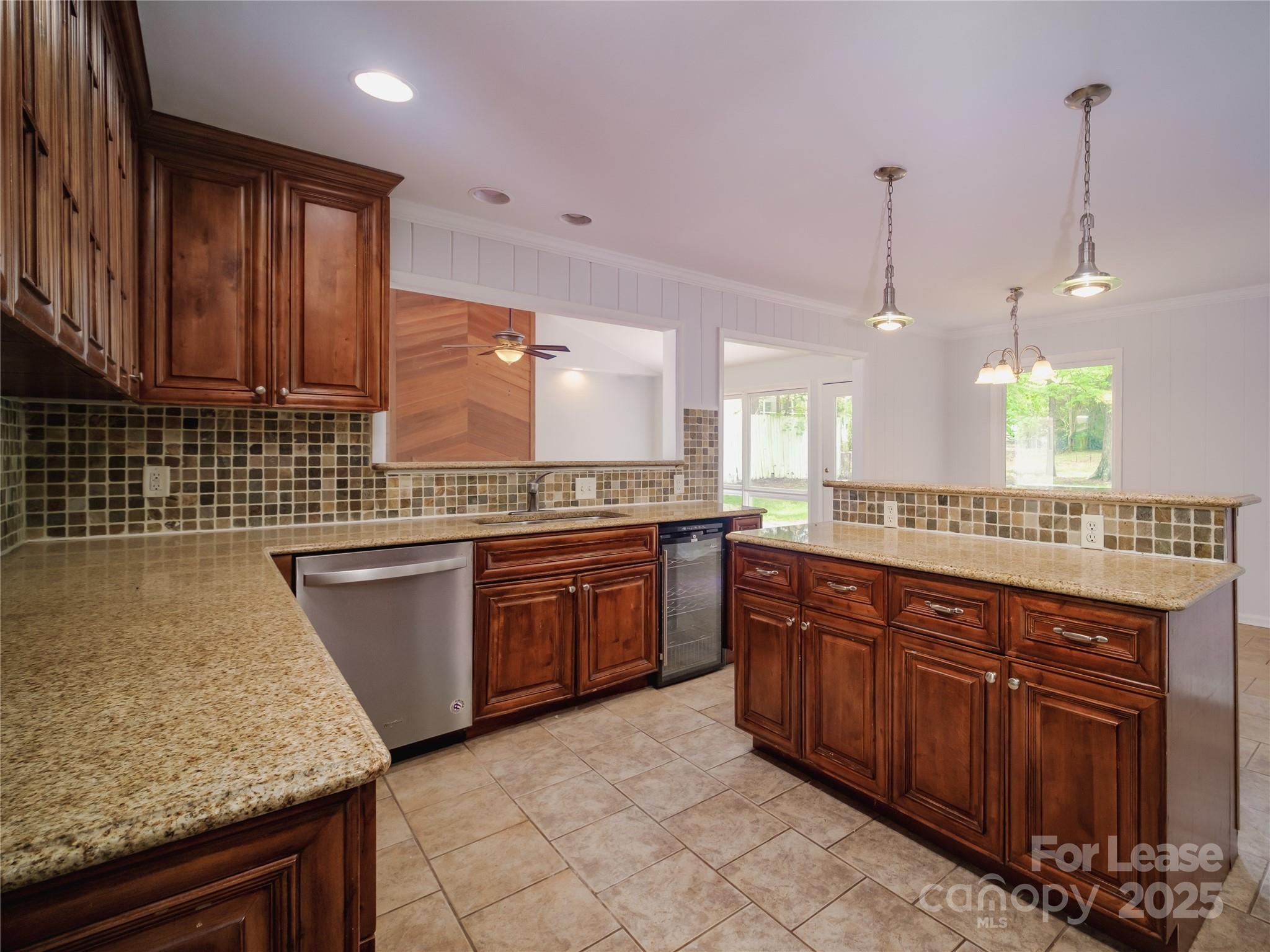 1123 Lynbrook Drive Charlotte, NC 28211 - Photo 19 of 47 a large kitchen with kitchen island granite countertop wooden cabinets a sink and dishwasher