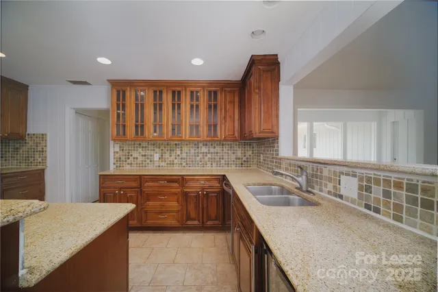 a kitchen with a sink stove and cabinets