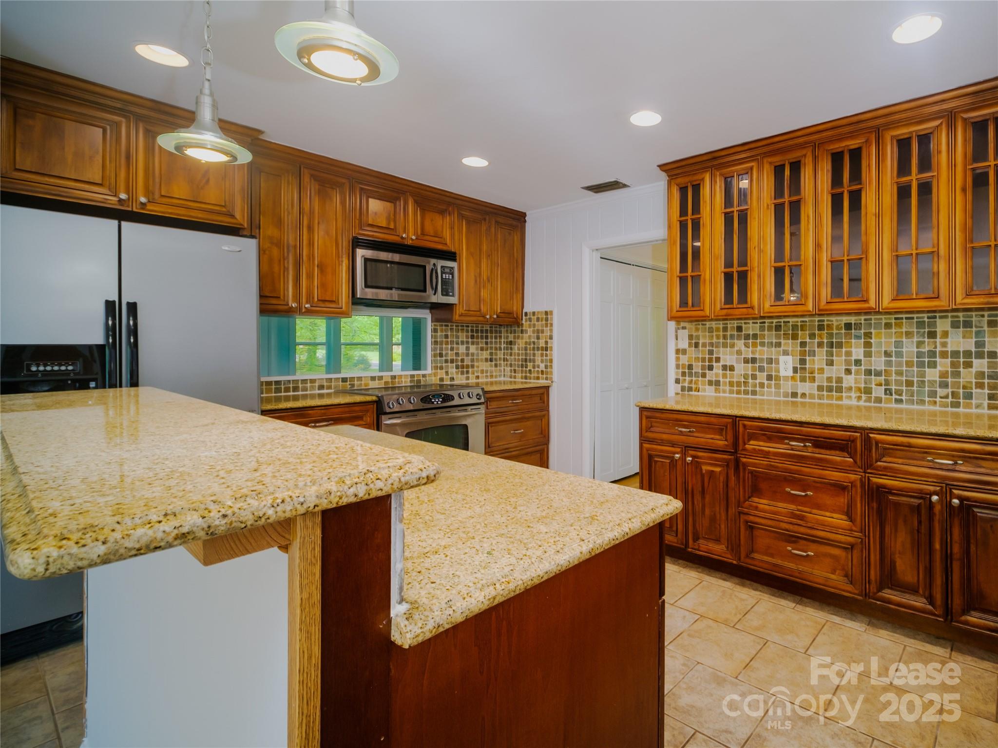 1123 Lynbrook Drive Charlotte, NC 28211 - Photo 22 of 47 a kitchen with stainless steel appliances kitchen island granite countertop a sink and cabinets