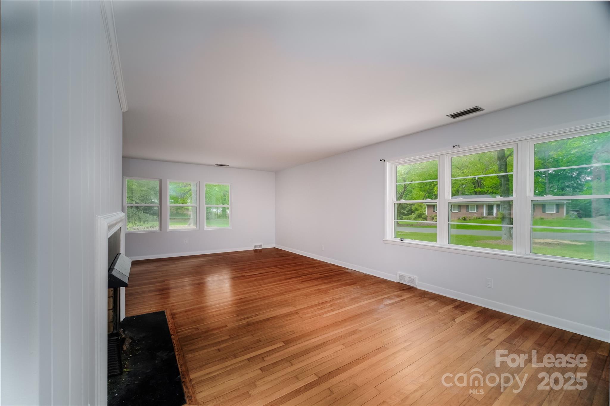 1123 Lynbrook Drive Charlotte, NC 28211 - Photo 24 of 47 a view of an empty room with wooden floor and a window