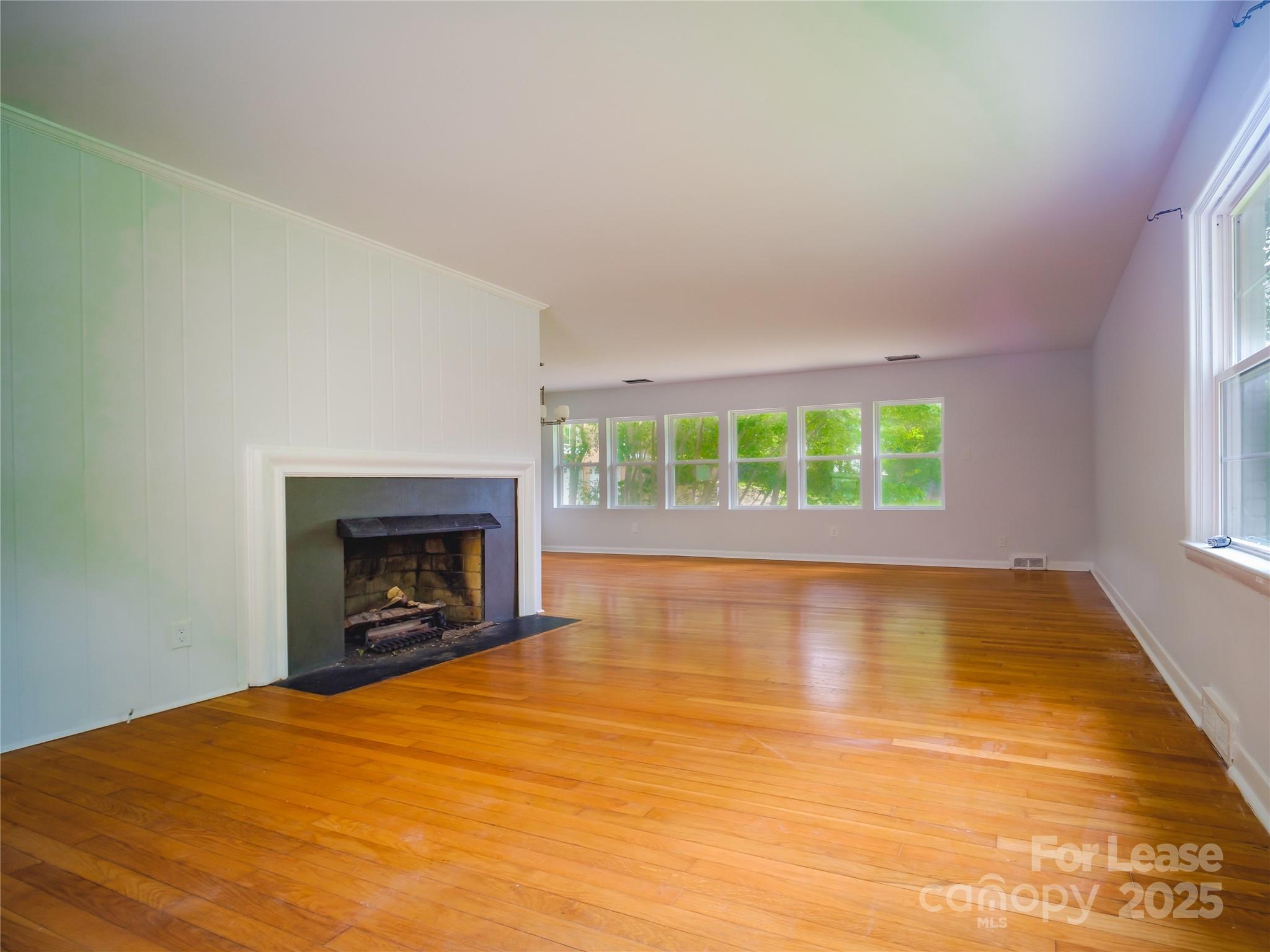 1123 Lynbrook Drive Charlotte, NC 28211 - Photo 25 of 47 an empty room with a fireplace and window