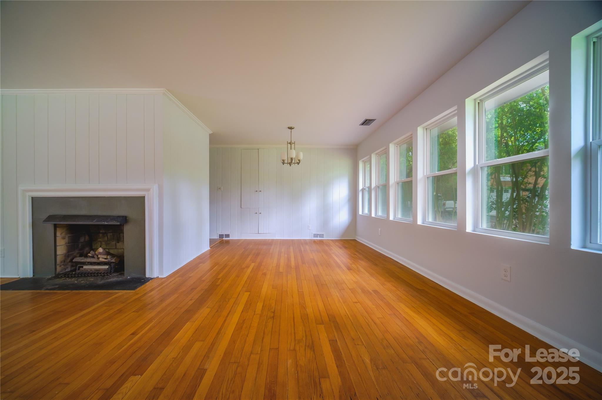 1123 Lynbrook Drive Charlotte, NC 28211 - Photo 26 of 47 a view of empty room with wooden floor and fireplace
