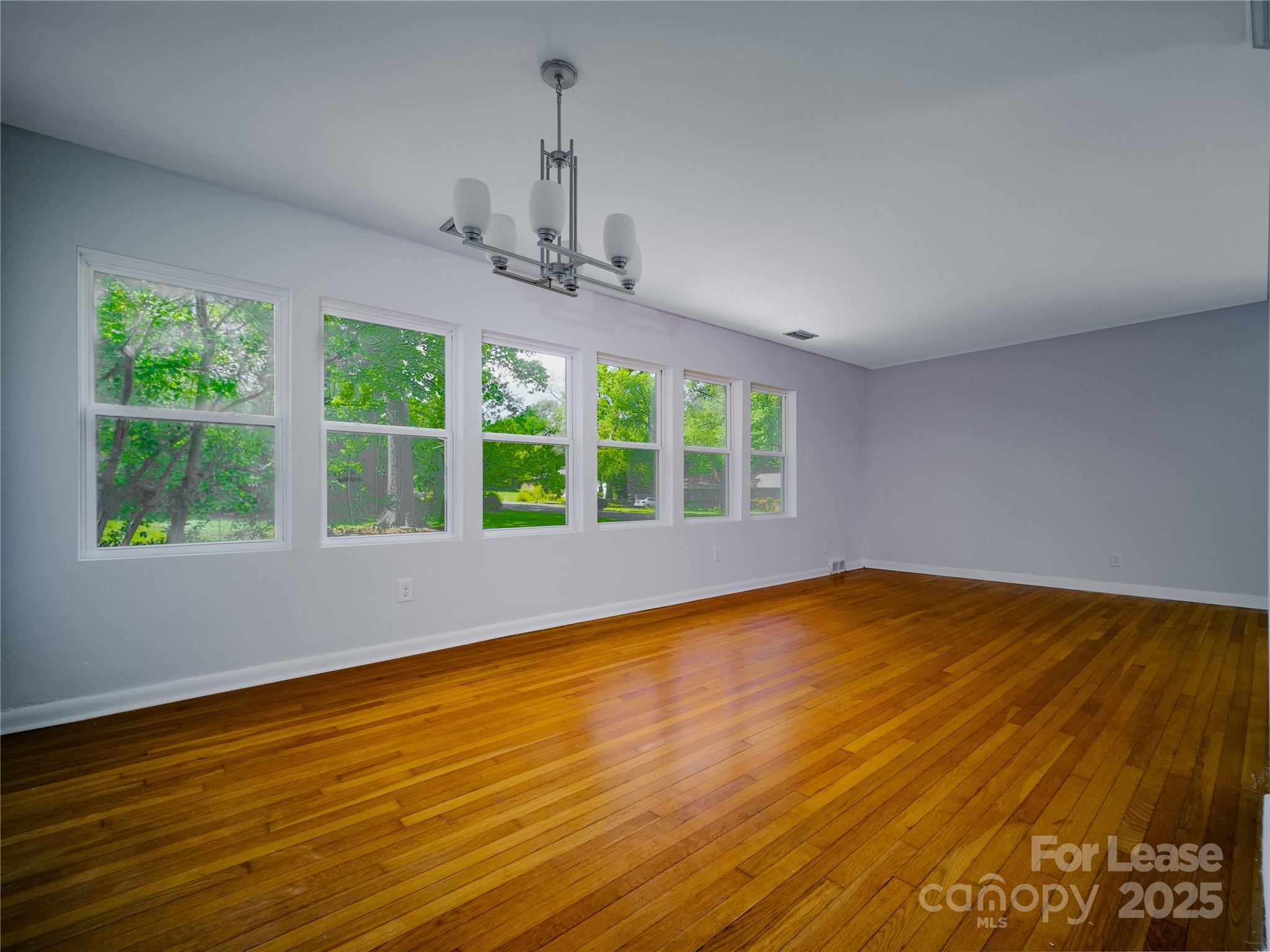 1123 Lynbrook Drive Charlotte, NC 28211 - Photo 29 of 47 a view of an empty room with wooden floor and a window
