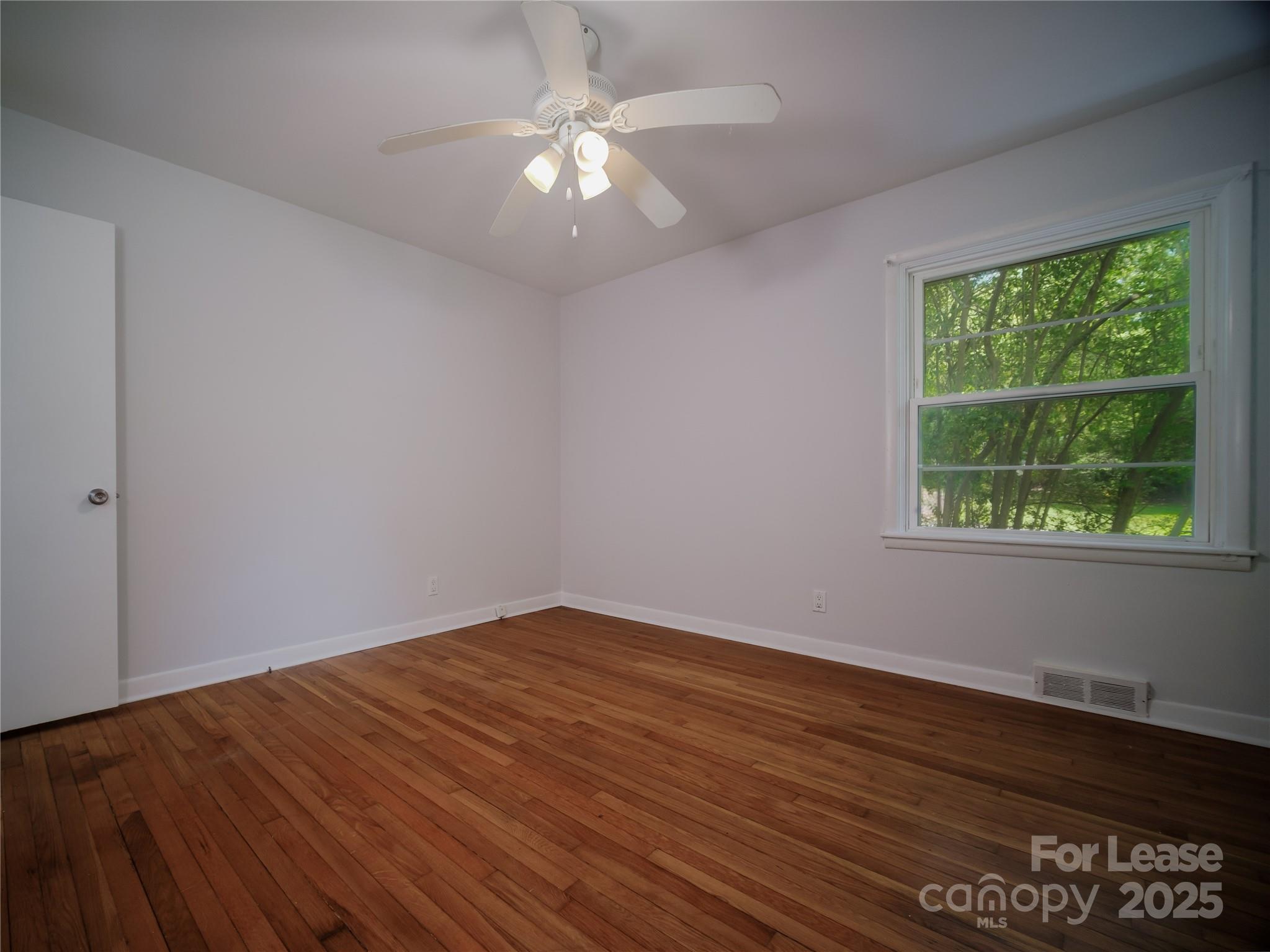 1123 Lynbrook Drive Charlotte, NC 28211 - Photo 32 of 47 an empty room with wooden floor and windows