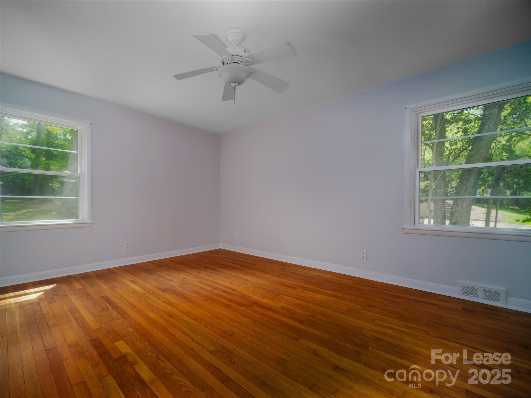 1123 Lynbrook Drive Charlotte, NC 28211 - Photo 34 of 47 an empty room with wooden floor and windows