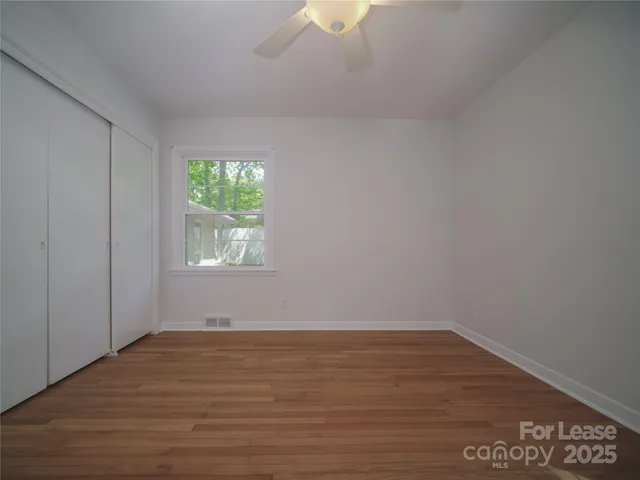 a view of room with window and hardwood floor