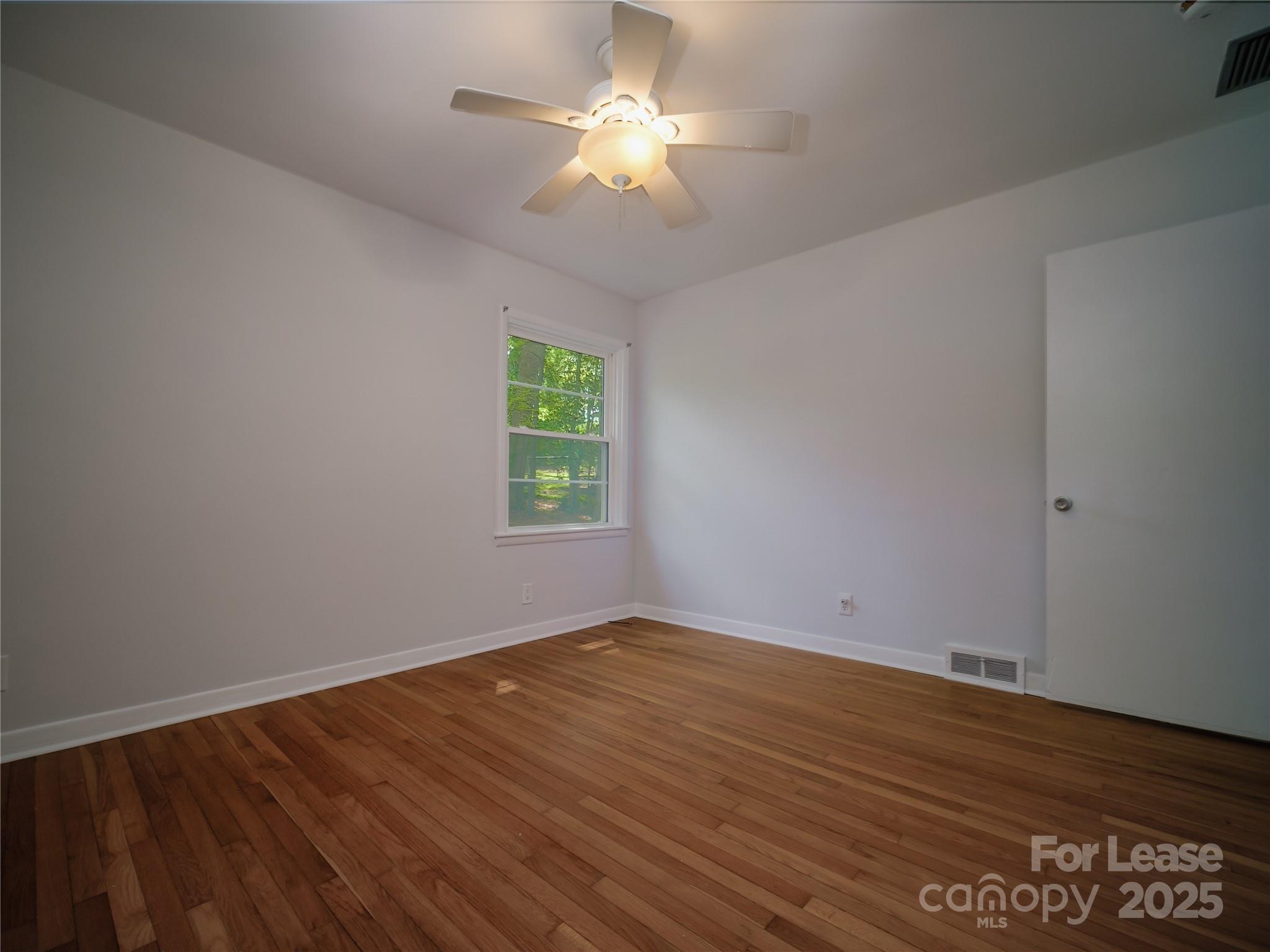 1123 Lynbrook Drive Charlotte, NC 28211 - Photo 40 of 47 wooden floor in an empty room with a window