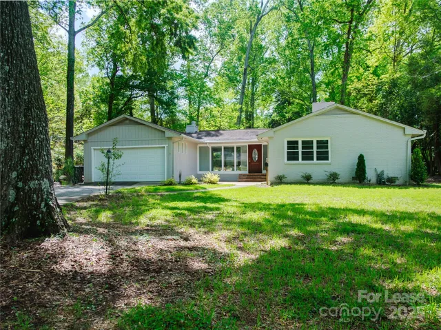 a house that is sitting in middle of the forest