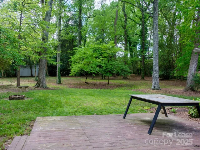 a view of a backyard with sitting area