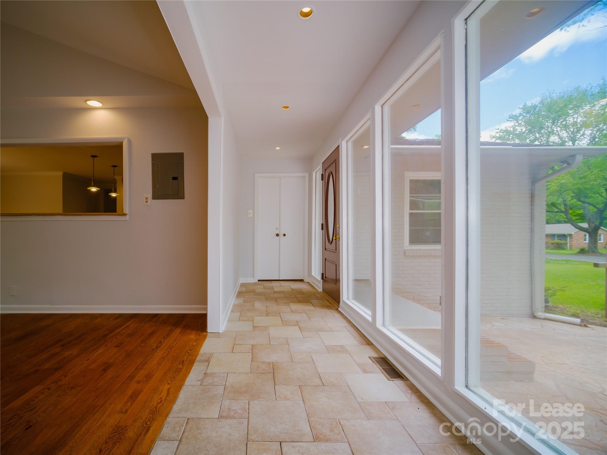 1123 Lynbrook Drive Charlotte, NC 28211 - Photo 5 of 47 a view of a hallway with wooden floor and a living room