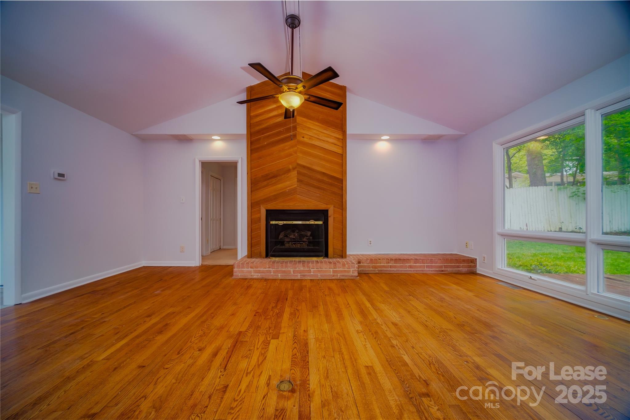 1123 Lynbrook Drive Charlotte, NC 28211 - Photo 8 of 47 a view of an empty room with a fireplace and a window