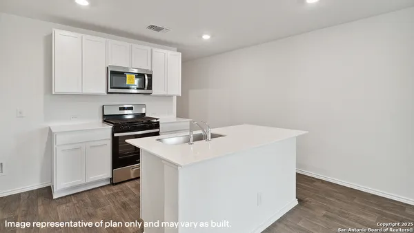 a kitchen with stainless steel appliances granite countertop a stove and a microwave
