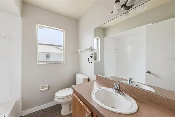 a bathroom with a sink toilet and a mirror