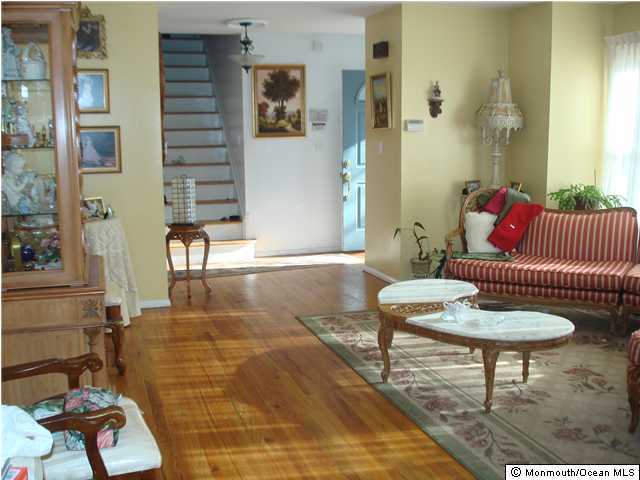 75 Newbury Road Howell, NJ 07731 - Photo 2 of 3 a living room with furniture and a rug