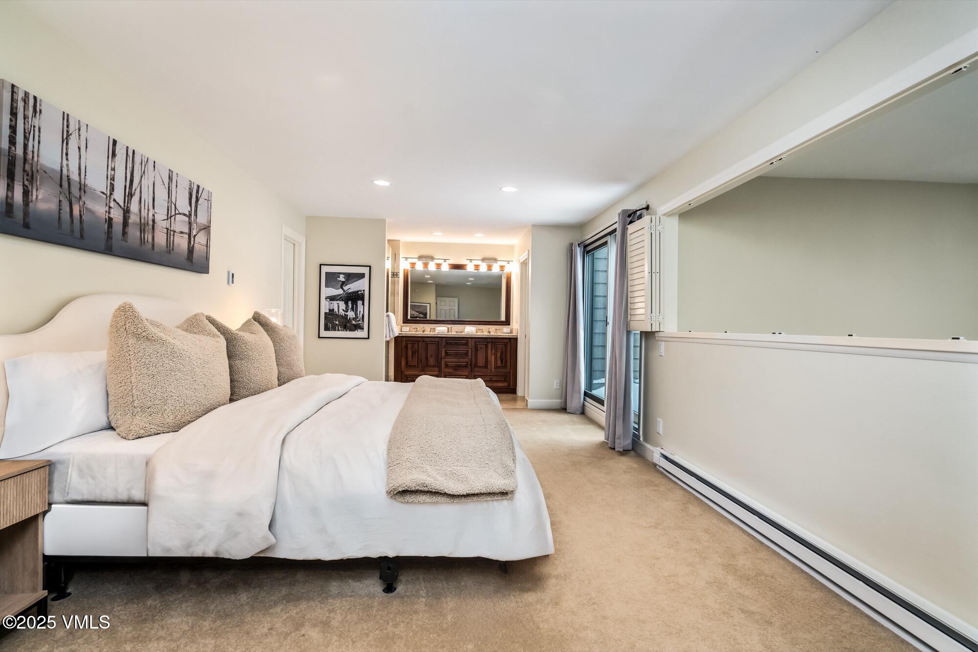 945 Red Sandstone Road, Unit A5 Vail, CO 81657 - Photo 21 of 38 a bedroom with a large bed and a dresser
