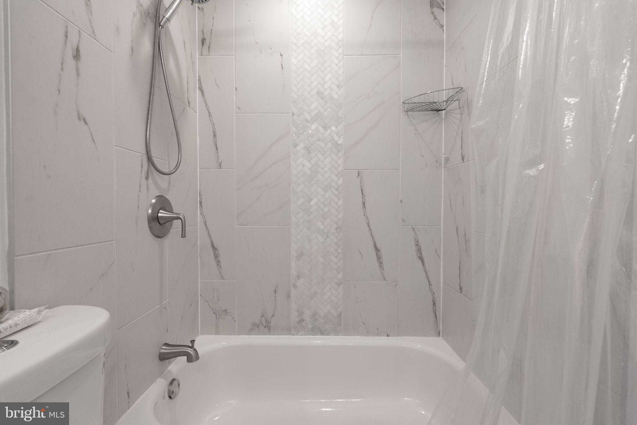 2000 East A Street Northeast Washington, DC 20002 - Photo 18 of 26 a bathroom with a bath tub with a shower