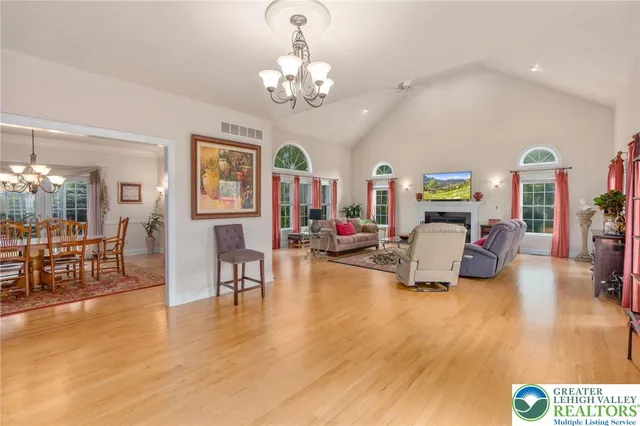 a living room with furniture and a chandelier