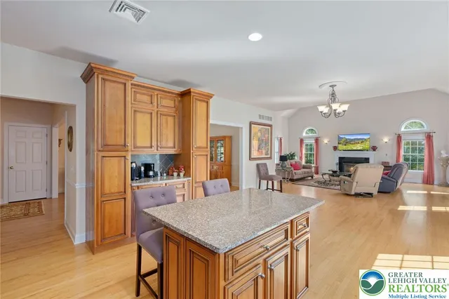 a kitchen with a table chairs refrigerator and cabinets
