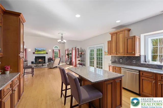 a kitchen with stainless steel appliances granite countertop a refrigerator and a stove top oven