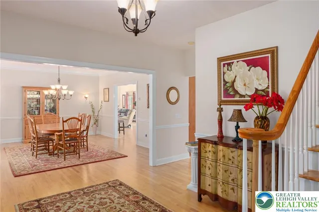 a dining room with furniture and a chandelier