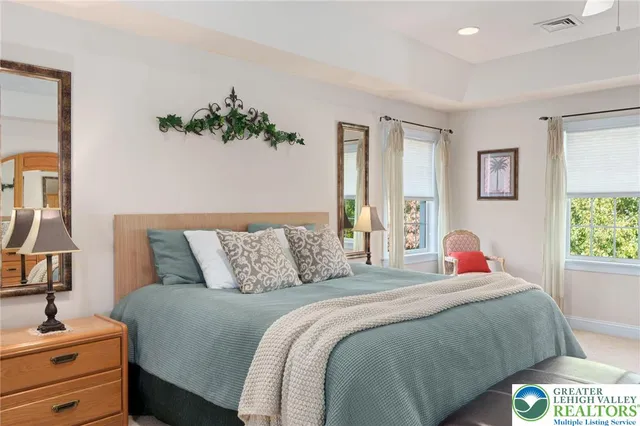 a bathroom with a granite countertop sink mirror and a refrigerator