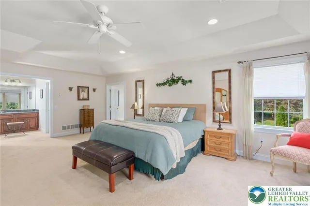a bathroom with a granite countertop tub sink and mirror