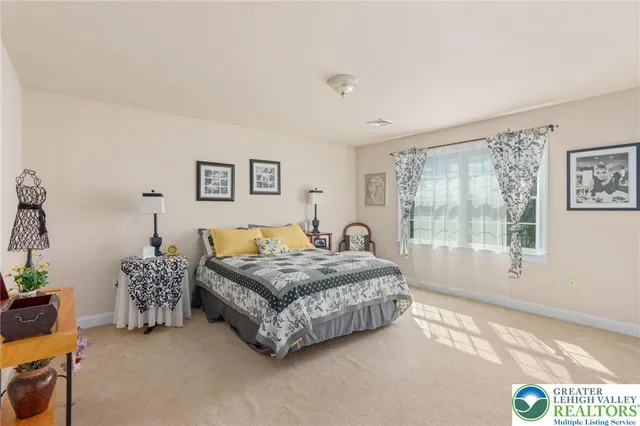 a spacious bathroom with a granite countertop double vanity sink a mirror and a shower