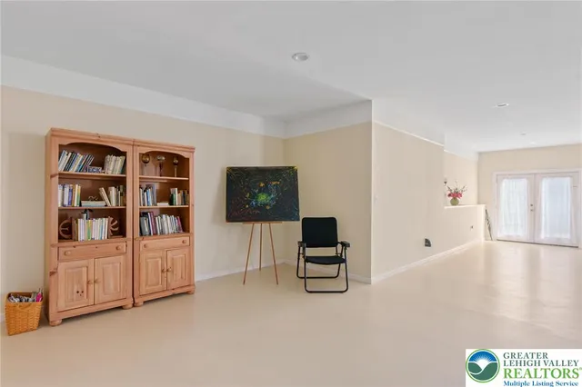 a view of a brick house with a yard and table and chairs under an umbrella