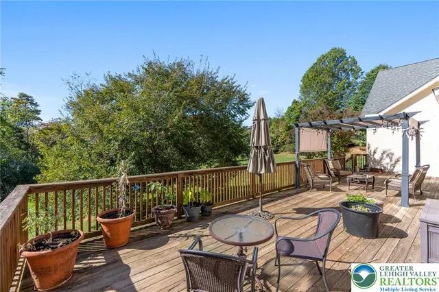 a aerial view of a house with garden space and trees in the background