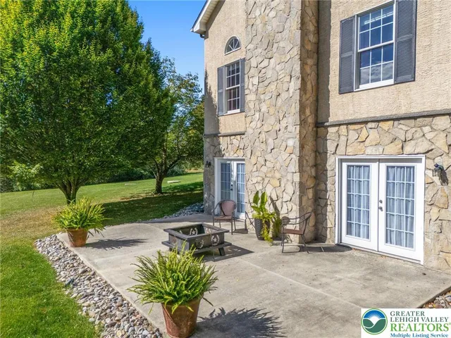 an aerial view of a residential houses covered in trees