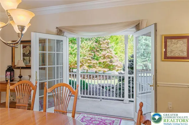 a view of a porch with a table and chairs