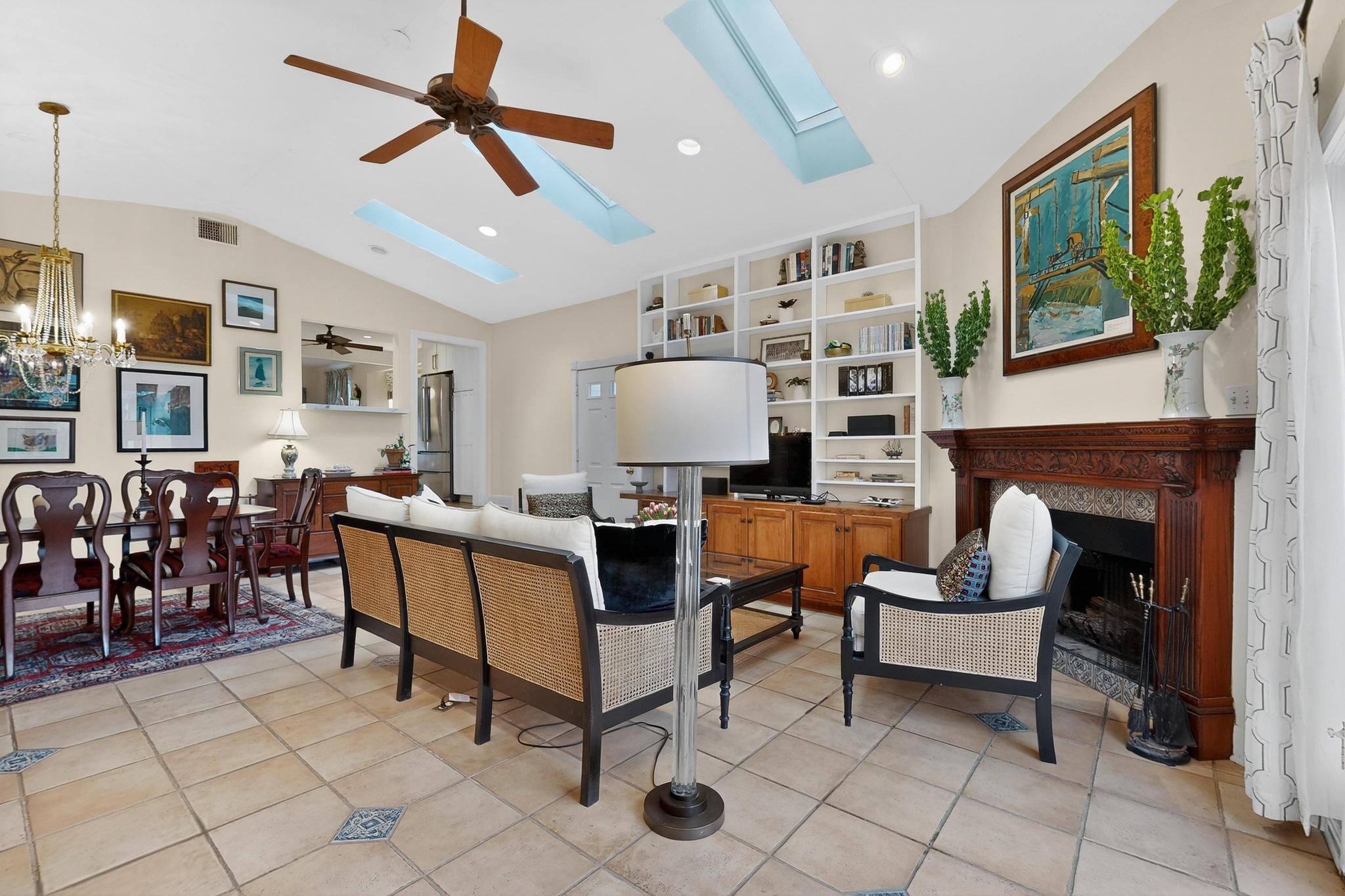 1906 Collier Street Austin, TX 78704 - Photo 14 of 40 Living room featuring ceiling fan, a skylight, a high end fireplace, suspended lighting, and vaulted ceiling.