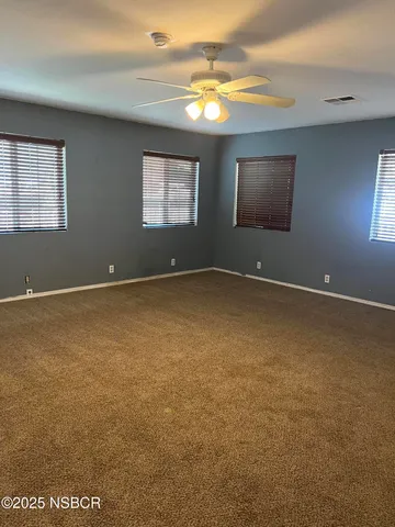 an empty room with windows and closet