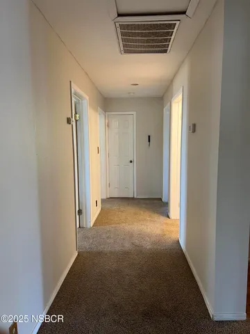 a view of a hallway with a room