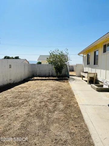 a bedroom with a large bed and large trees