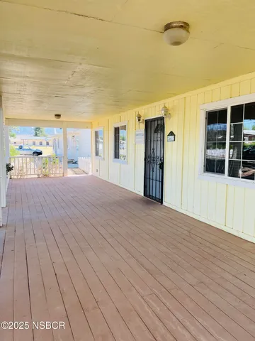 a big room with wooden floor and windows