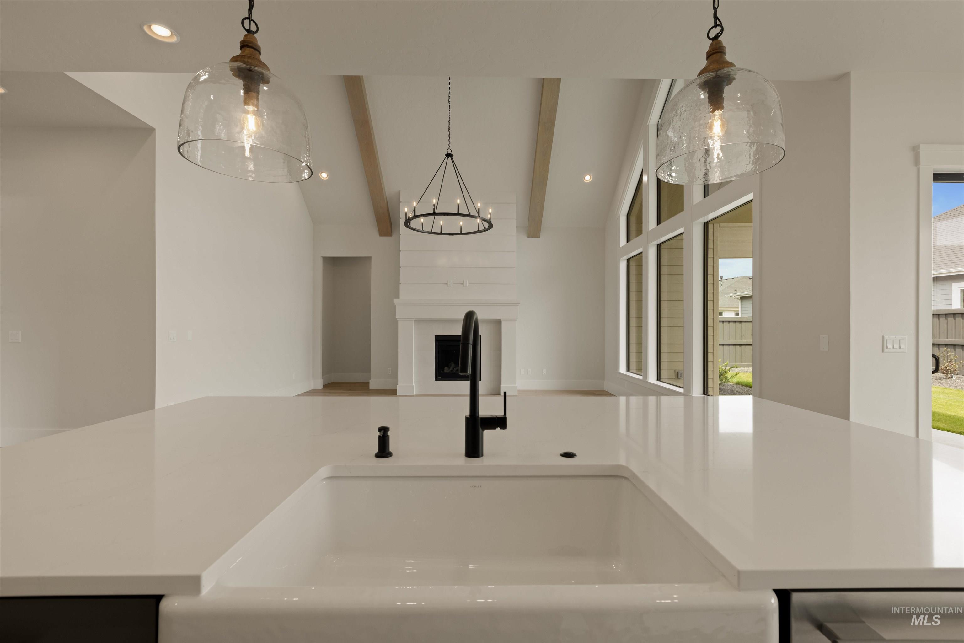 2595 East Tenzing Drive Meridian, ID 83642 - Photo 32 of 32 Kitchen with recessed lighting, pendant lighting, open floor plan, and light stone counters