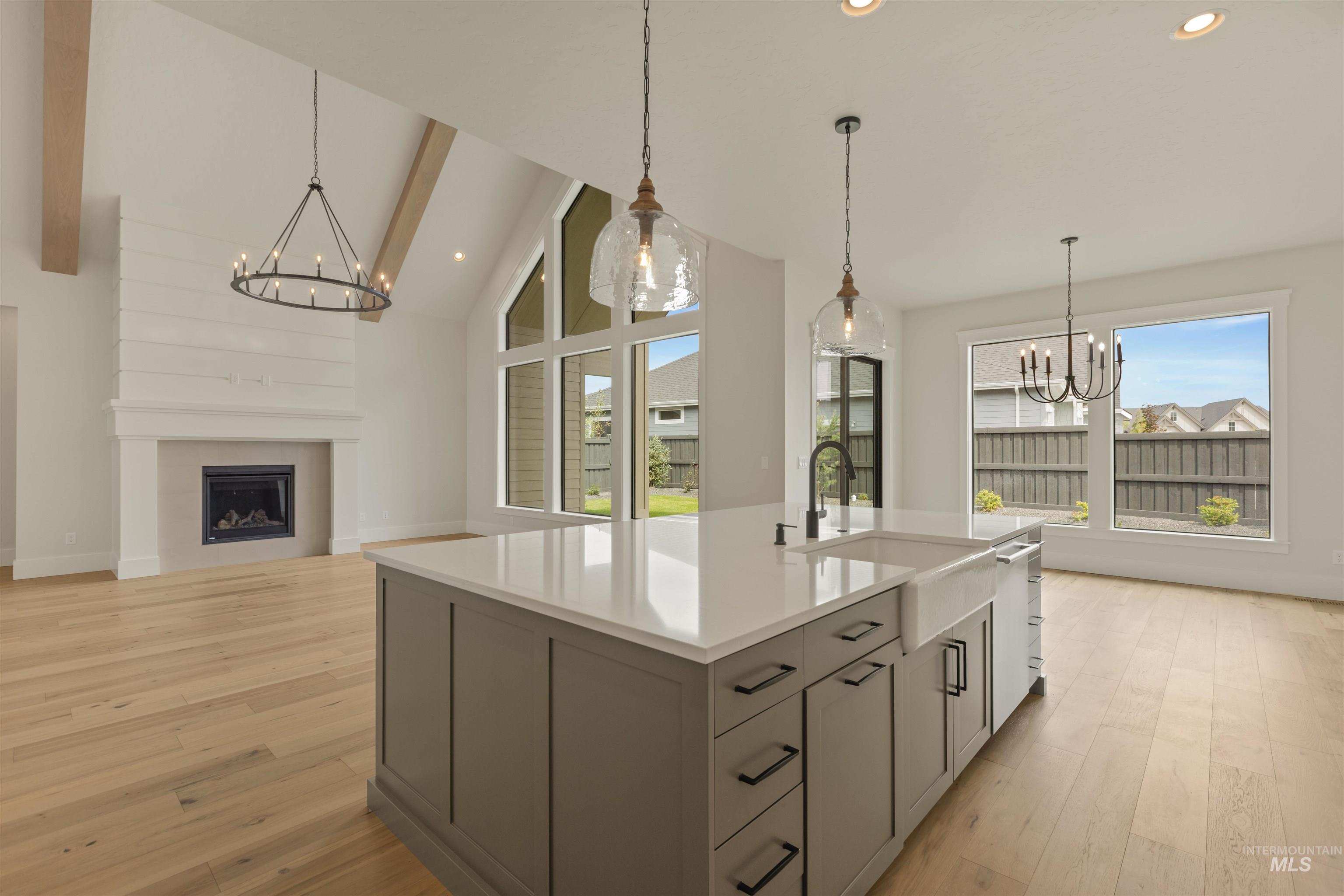 2595 East Tenzing Drive Meridian, ID 83642 - Photo 11 of 32 Kitchen with a chandelier, hanging light fixtures, light wood-type flooring, a fireplace, and recessed lighting