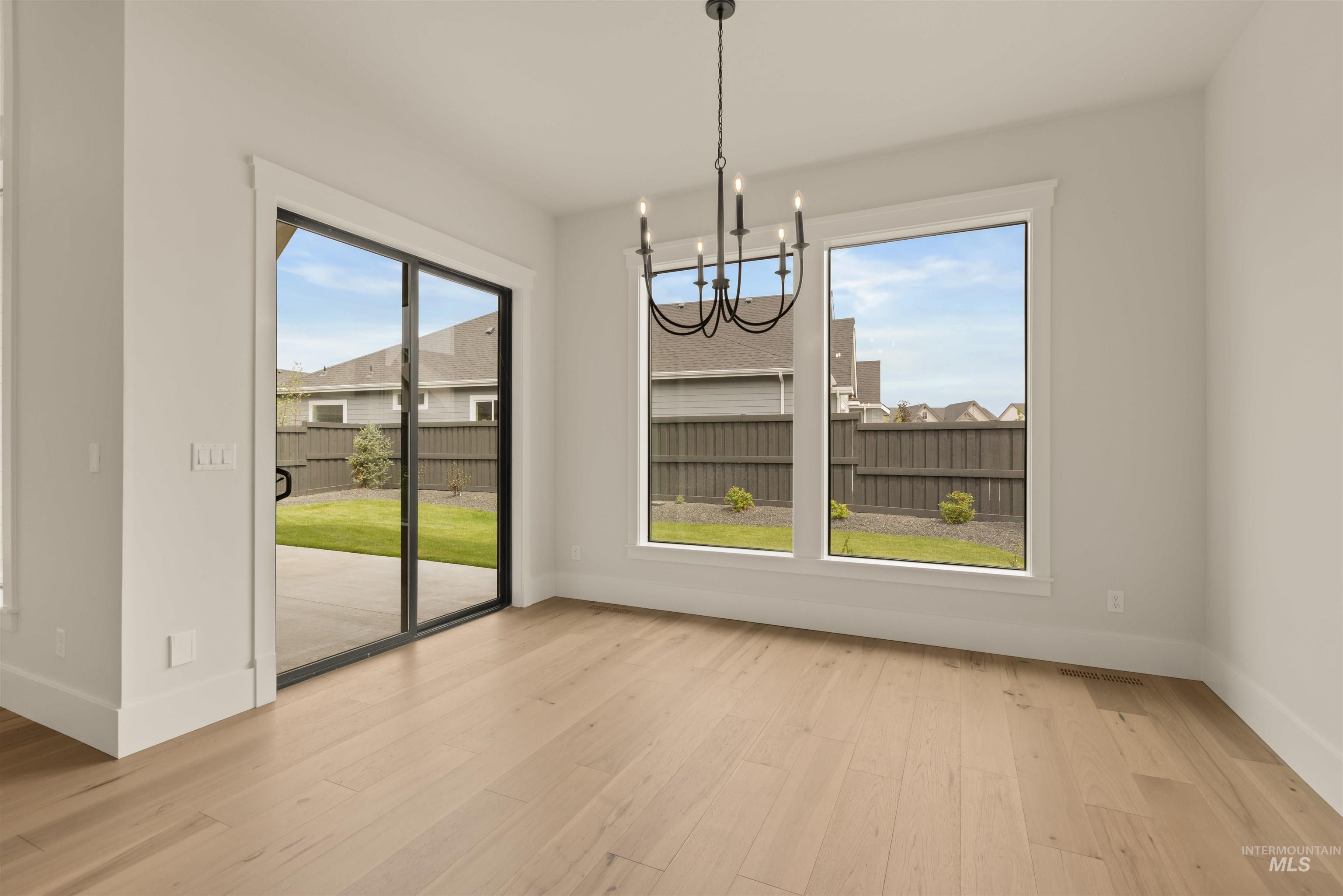 2595 East Tenzing Drive Meridian, ID 83642 - Photo 13 of 32 Unfurnished dining area featuring a chandelier and light wood-style floors