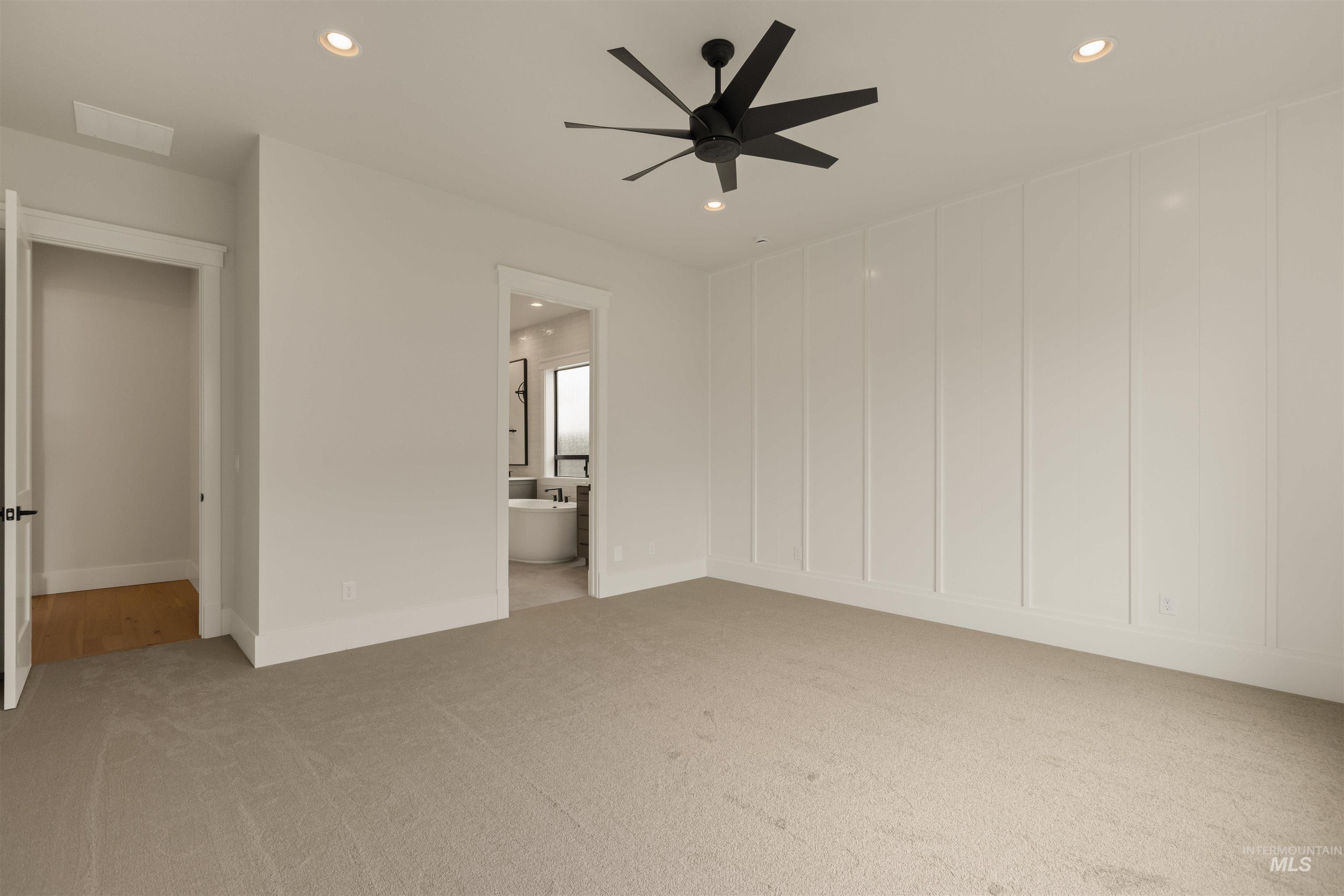 2595 East Tenzing Drive Meridian, ID 83642 - Photo 15 of 32 Unfurnished bedroom with recessed lighting, light colored carpet, ceiling fan, ensuite bathroom, and a decorative wall