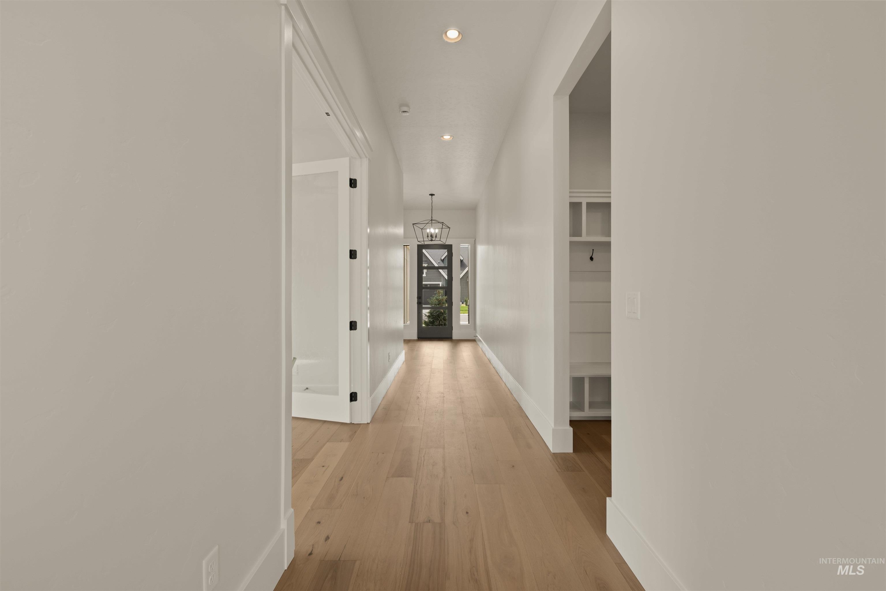 2595 East Tenzing Drive Meridian, ID 83642 - Photo 24 of 32 Corridor with recessed lighting, light wood finished floors, and a chandelier