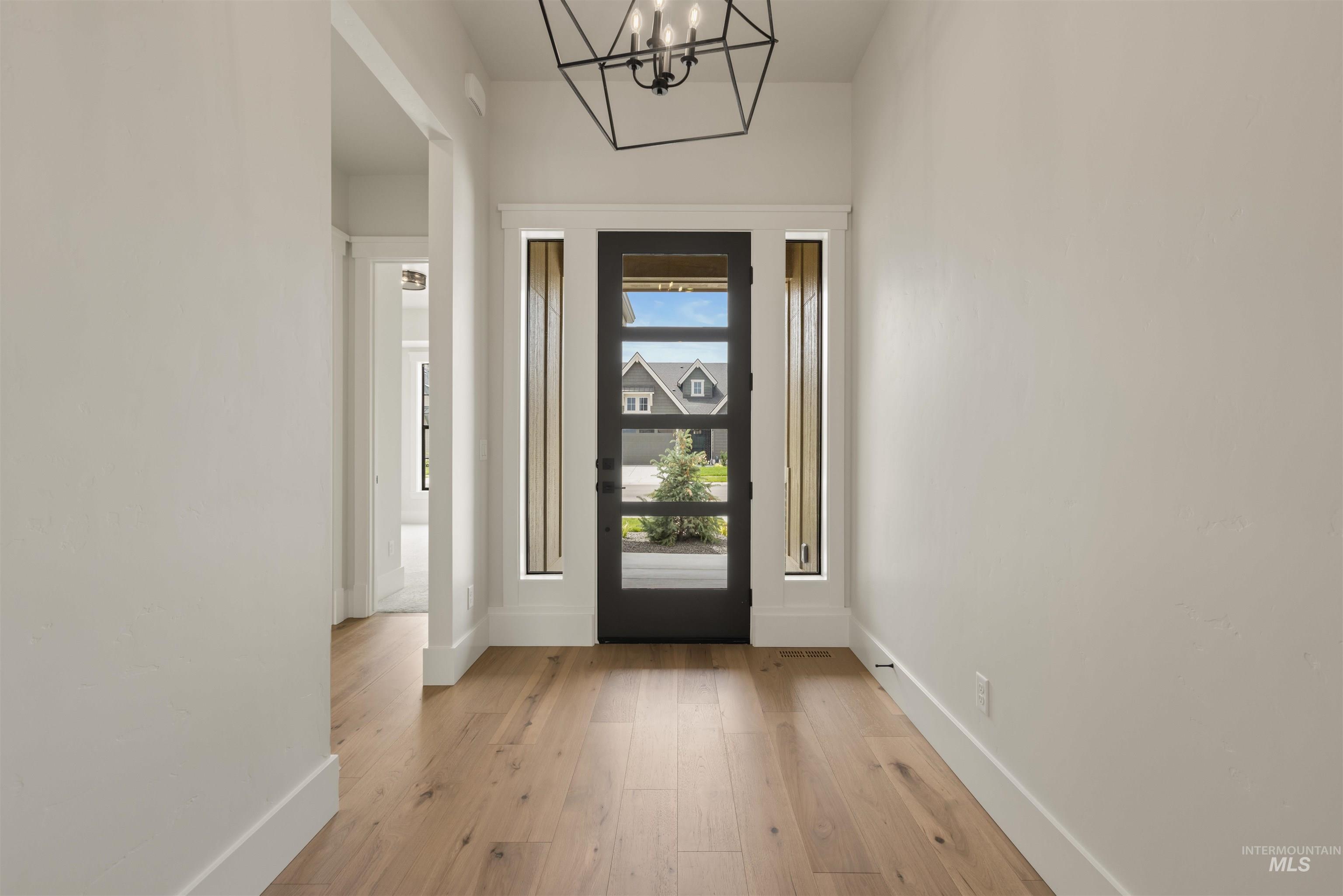2595 East Tenzing Drive Meridian, ID 83642 - Photo 25 of 32 Entryway featuring light wood-type flooring and a chandelier